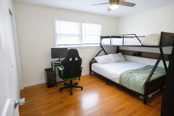 a bedroom with a bed and chair