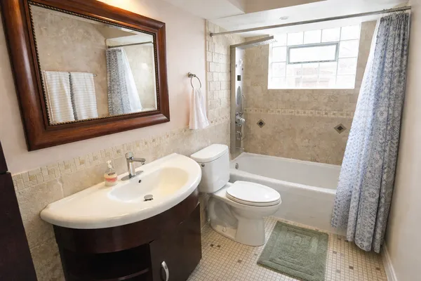 a bathroom with a sink toilet a mirror and shower