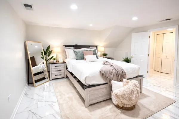 a bedroom with a bed and a couch