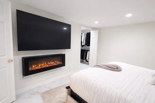 a bedroom with a bed and a fireplace