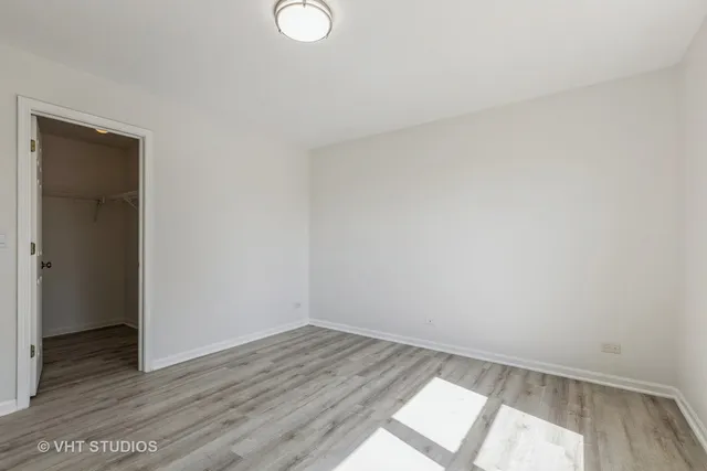 a view of an empty room and wooden floor