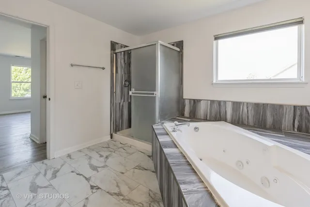 a bathroom with a bathtub and a shower