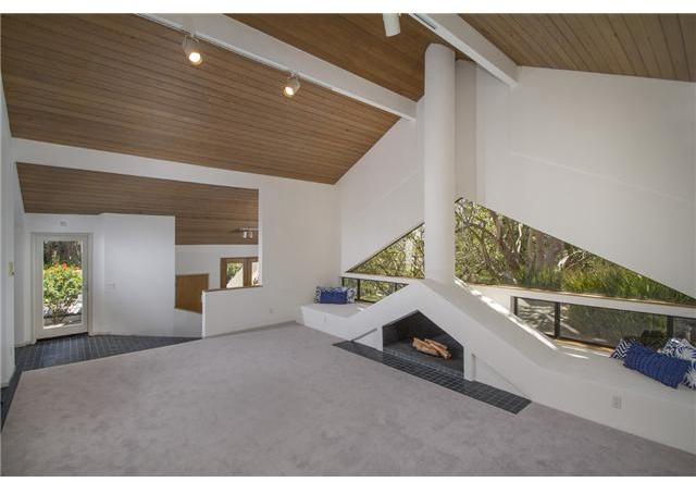 4920 Rancho Grande Del Mar, CA 92014 - Photo 17 of 25 Sharp white walls contrasted with wood ceilings and walls of glass in the gorgeous living room.