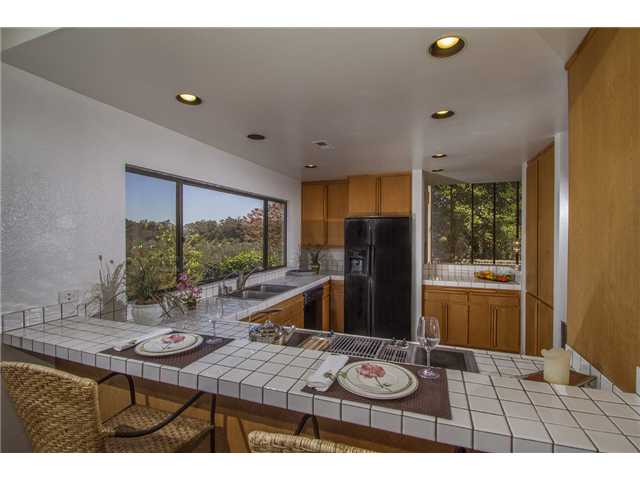 4920 Rancho Grande Del Mar, CA 92014 - Photo 9 of 25 Intimate kitchen with walls of storage on one side and lots of counters for the gourmet cook.
