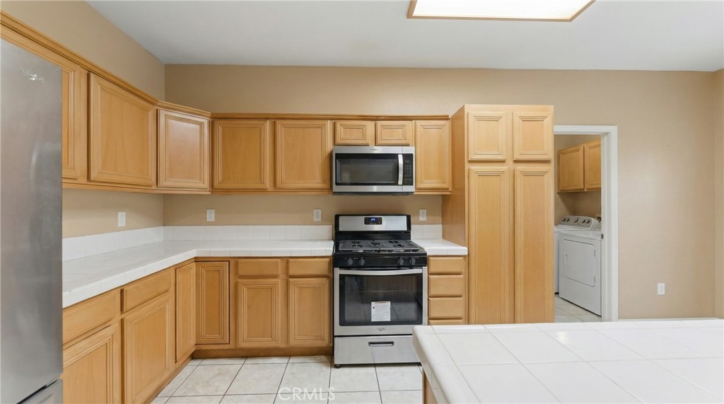 11368 Cactus Avenue Bloomington, CA 92316 - Photo 11 of 32 a kitchen with stainless steel appliances granite countertop a refrigerator and a stove top oven