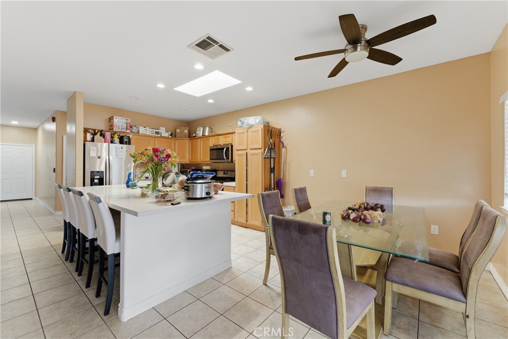11368 Cactus Avenue Bloomington, CA 92316 - Photo 13 of 32 a view of a dining room with furniture and a chandelier fan