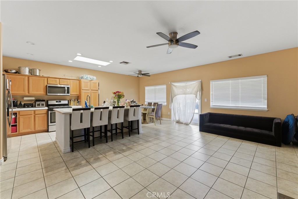 11368 Cactus Avenue Bloomington, CA 92316 - Photo 17 of 32 a living room with stainless steel appliances furniture and a kitchen view