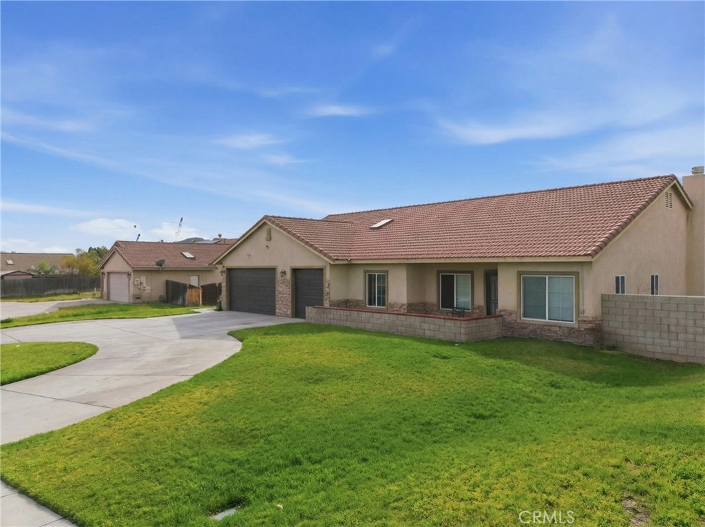 11368 Cactus Avenue Bloomington, CA 92316 - Photo 3 of 32 a view of a house with a big yard plants and large trees