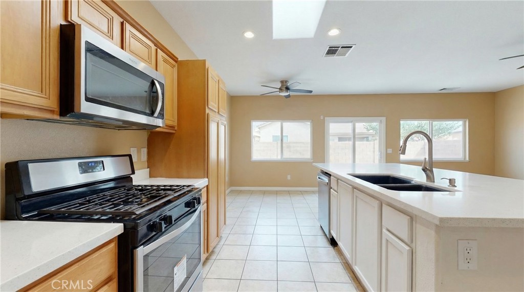 11368 Cactus Avenue Bloomington, CA 92316 - Photo 9 of 32 a kitchen with stainless steel appliances granite countertop a sink stove and cabinets