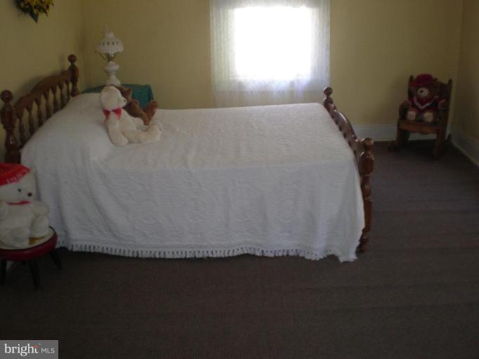 18152 Spring Run Road Dry Run, PA 17220 - Photo 15 of 29 a bed sitting in a bedroom next to a window