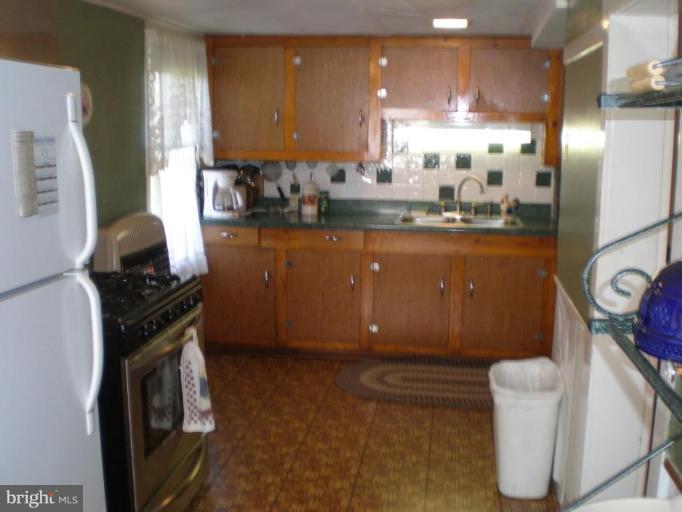 18152 Spring Run Road Dry Run, PA 17220 - Photo 2 of 29 a kitchen with granite countertop a stove and a refrigerator