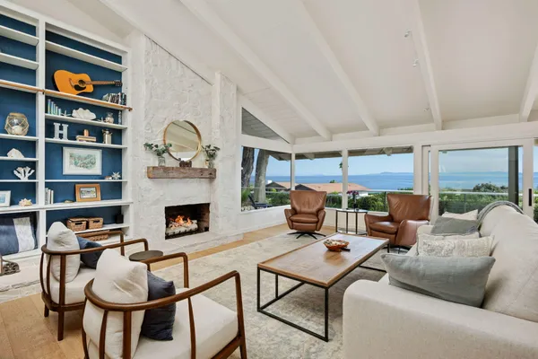 a living room with patio furniture and a fireplace