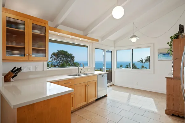 a kitchen with stainless steel appliances granite countertop a sink counter space cabinets and a large window