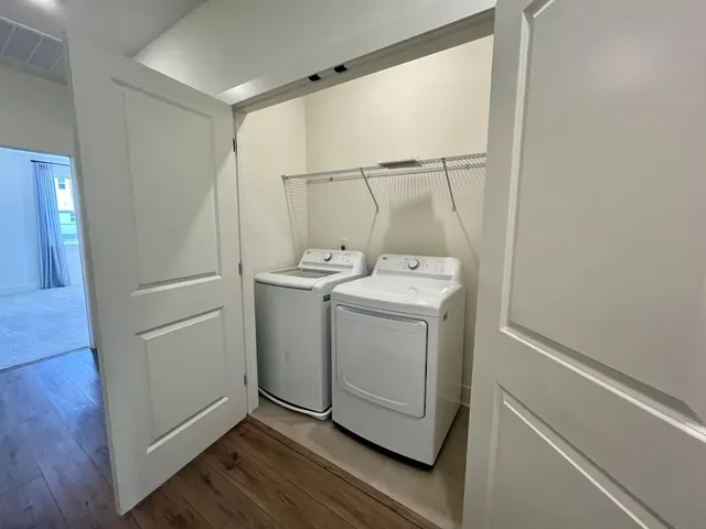 a bathroom with a double vanity sink toilet mirror and bathtub