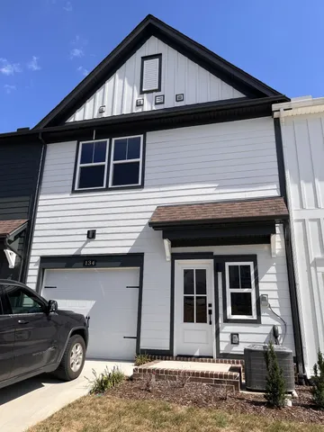 a front view of a house with parking space