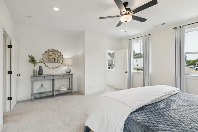 a spacious bedroom with a bed and a window