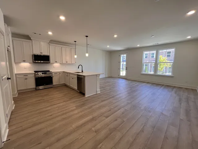 a spacious bathroom with a double vanity sink a mirror and a shower