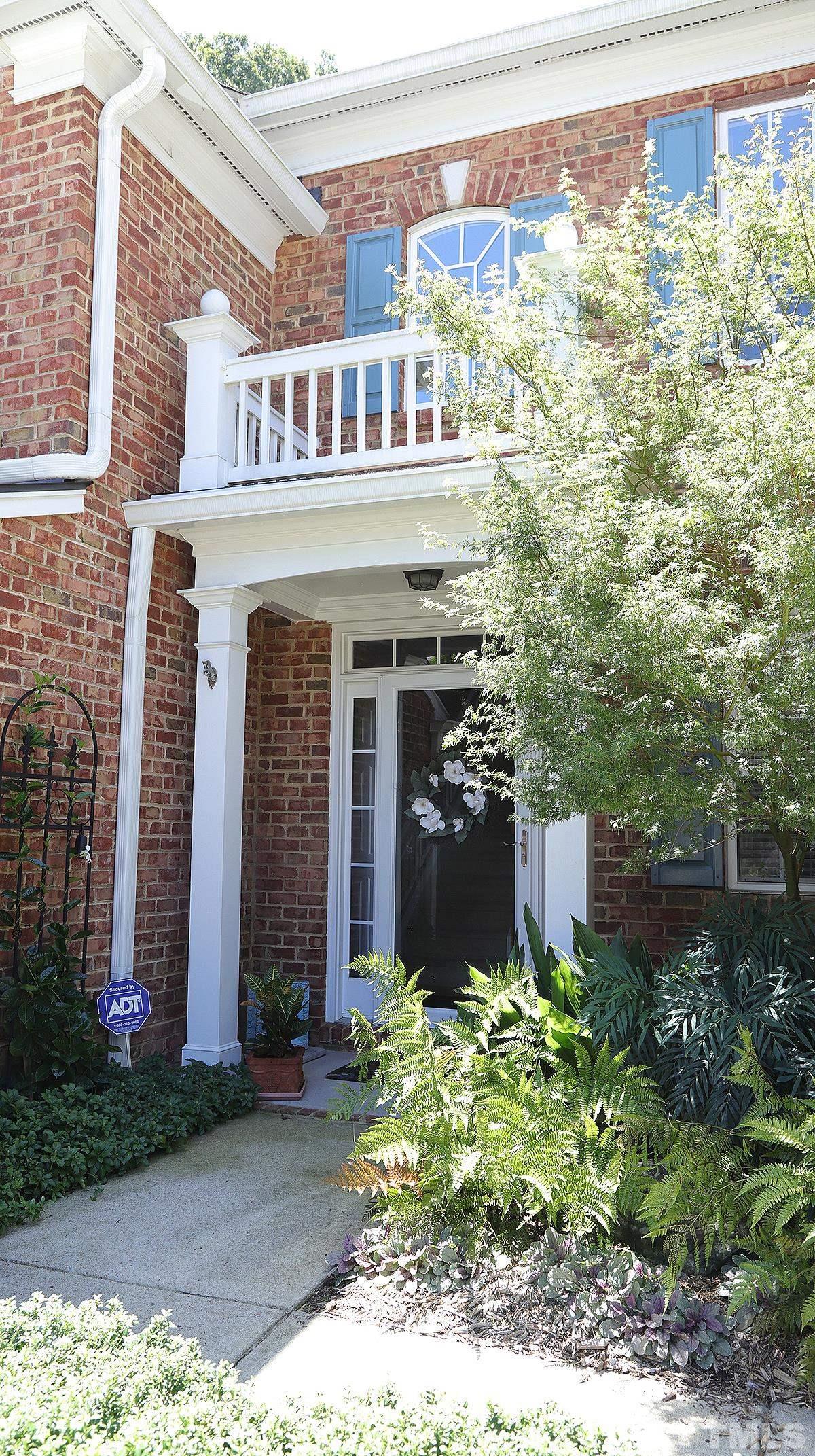 3621 Lion Ridge Court Raleigh, NC 27612 - Photo 2 of 34 a front view of a house with garden