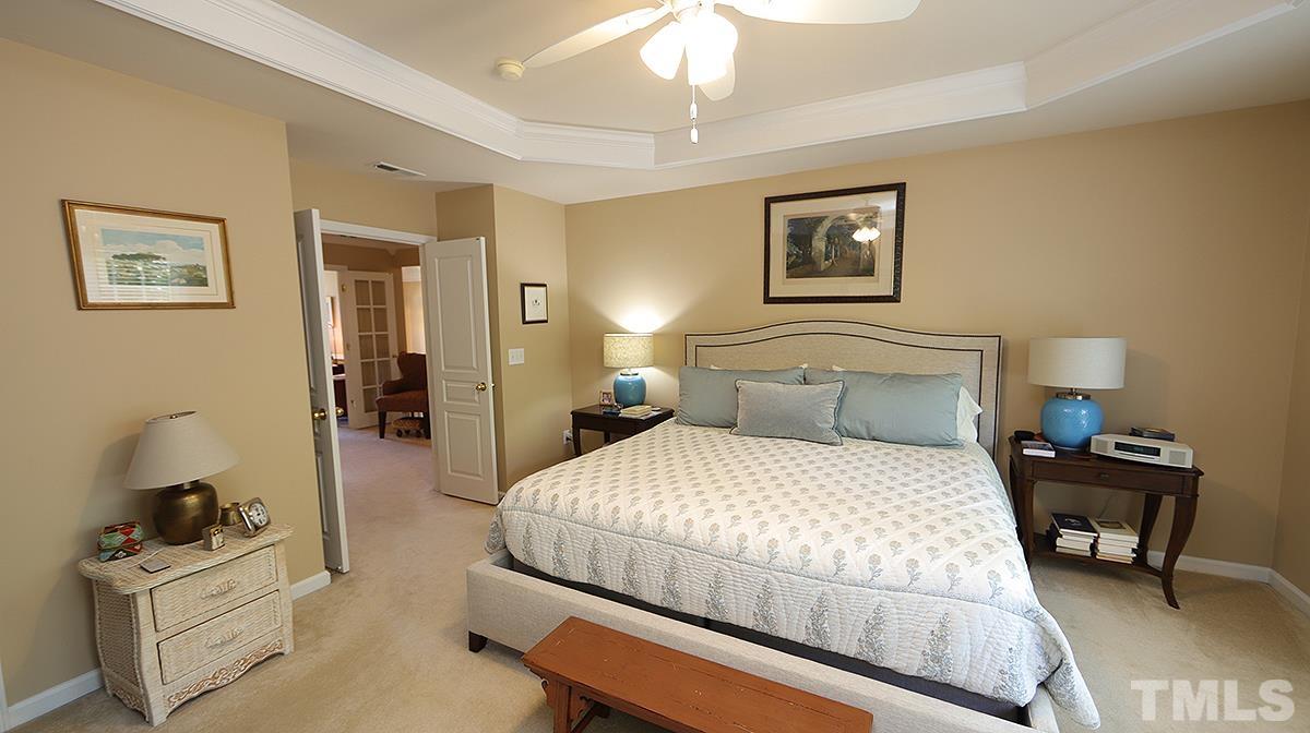 3621 Lion Ridge Court Raleigh, NC 27612 - Photo 21 of 34 a bedroom with a bed and wooden floor