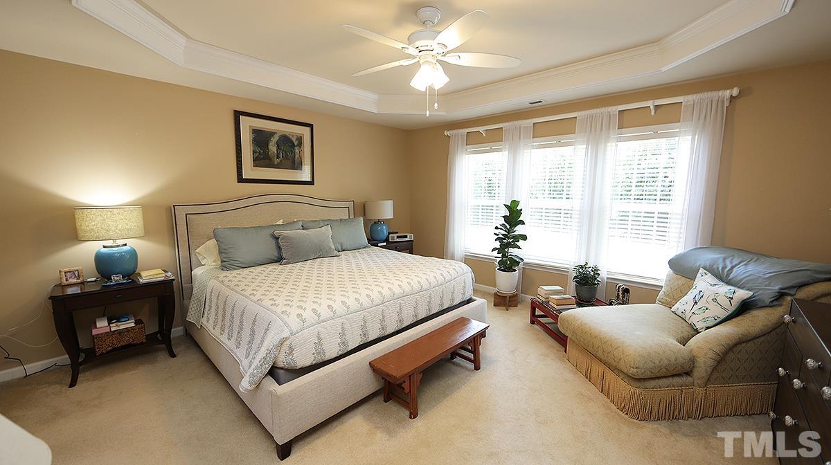 3621 Lion Ridge Court Raleigh, NC 27612 - Photo 22 of 34 a bedroom with a bed and window