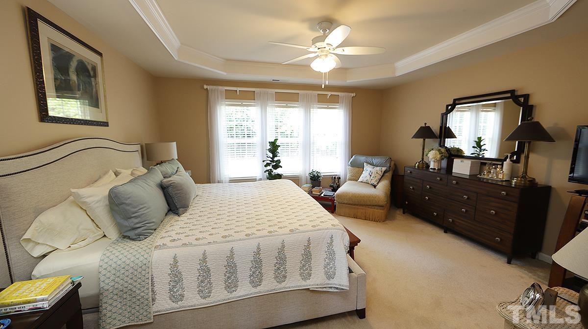 3621 Lion Ridge Court Raleigh, NC 27612 - Photo 23 of 34 a bedroom with a bed a couch and dresser