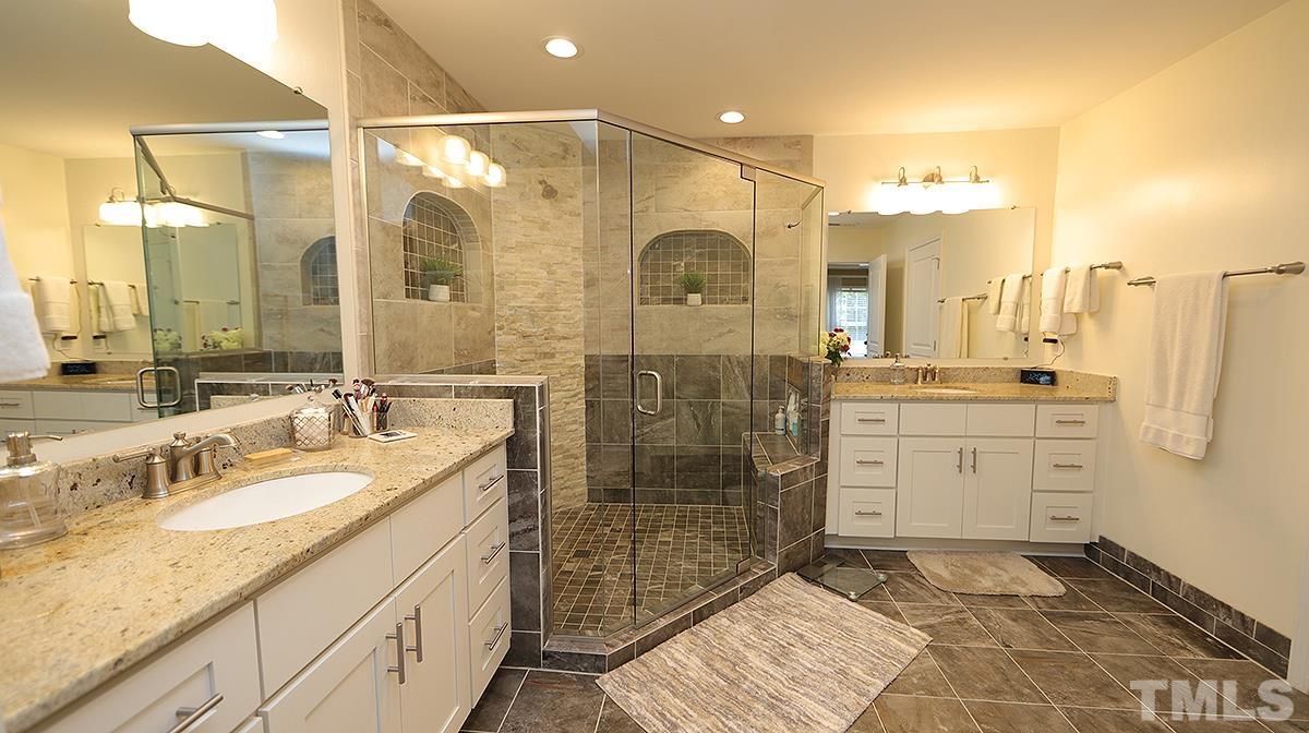 3621 Lion Ridge Court Raleigh, NC 27612 - Photo 24 of 34 a bathroom with a shower sink and mirror
