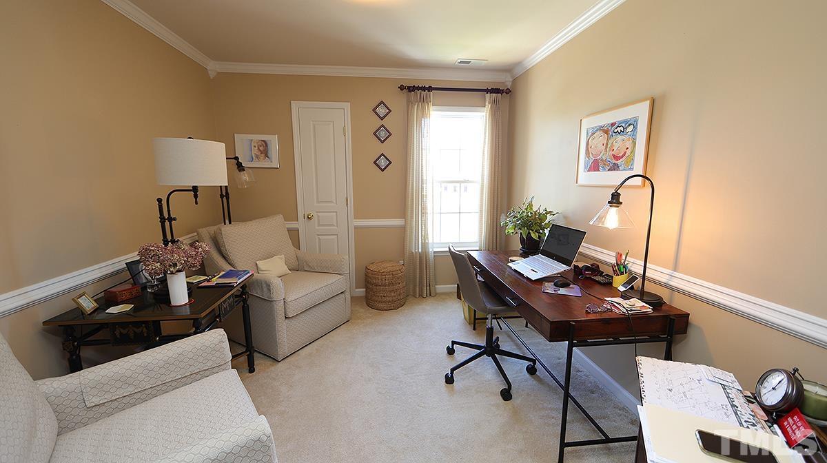 3621 Lion Ridge Court Raleigh, NC 27612 - Photo 29 of 34 a living room with furniture and a wooden floor