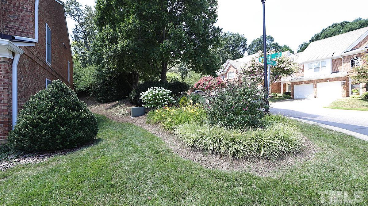 3621 Lion Ridge Court Raleigh, NC 27612 - Photo 4 of 34 a view of a garden with a house