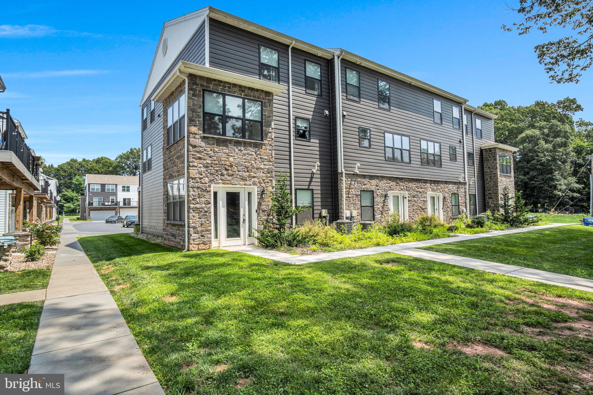 127 High Pointe Drive, Unit 31 Hummelstown, PA 17036 - Photo 2 of 28 Modern residential complex with lush greenery.