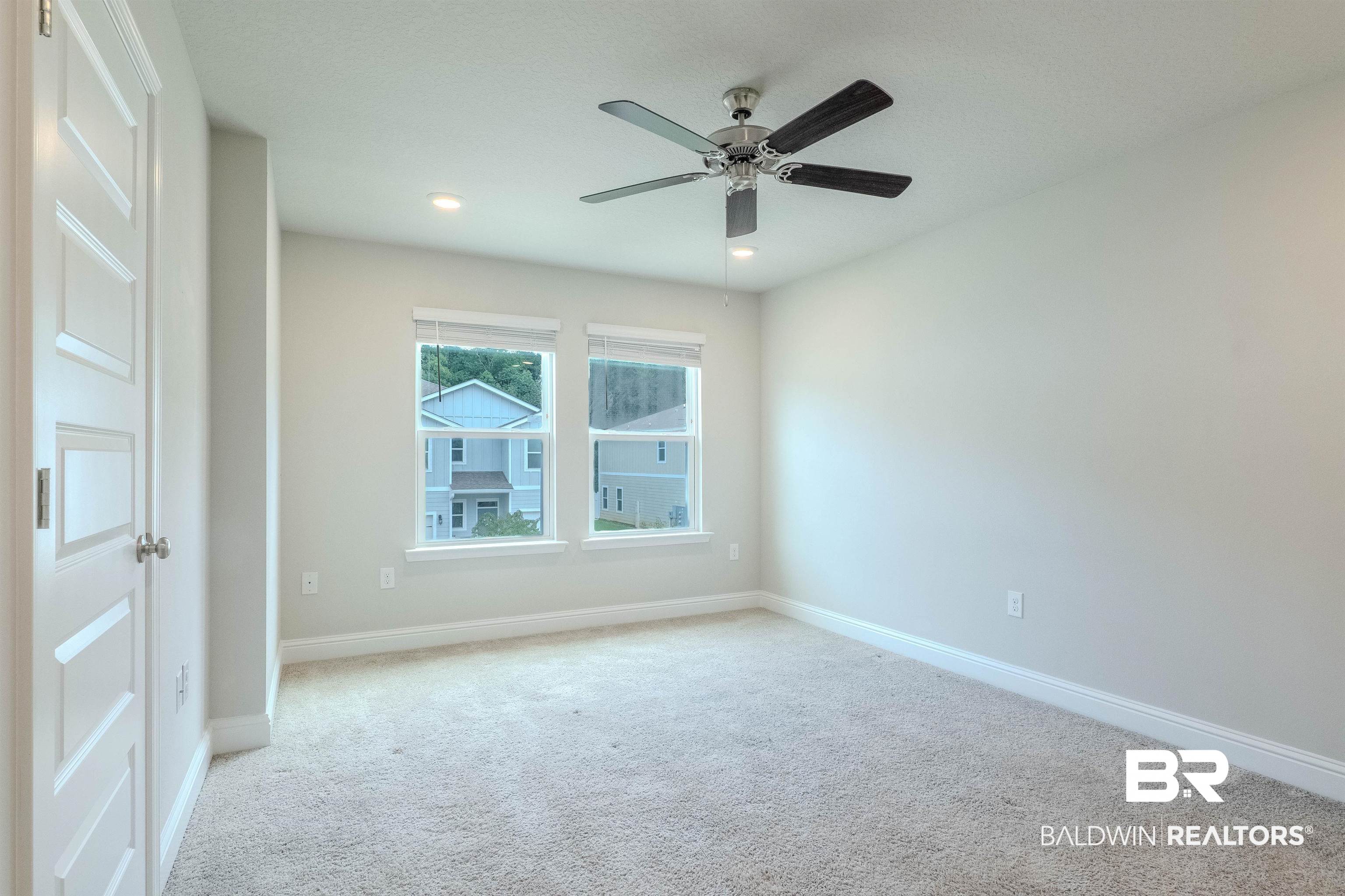 25806 Pollard Road, Unit 32 Daphne, AL 36526 - Photo 11 of 23 Spare room featuring ceiling fan and light colored carpet