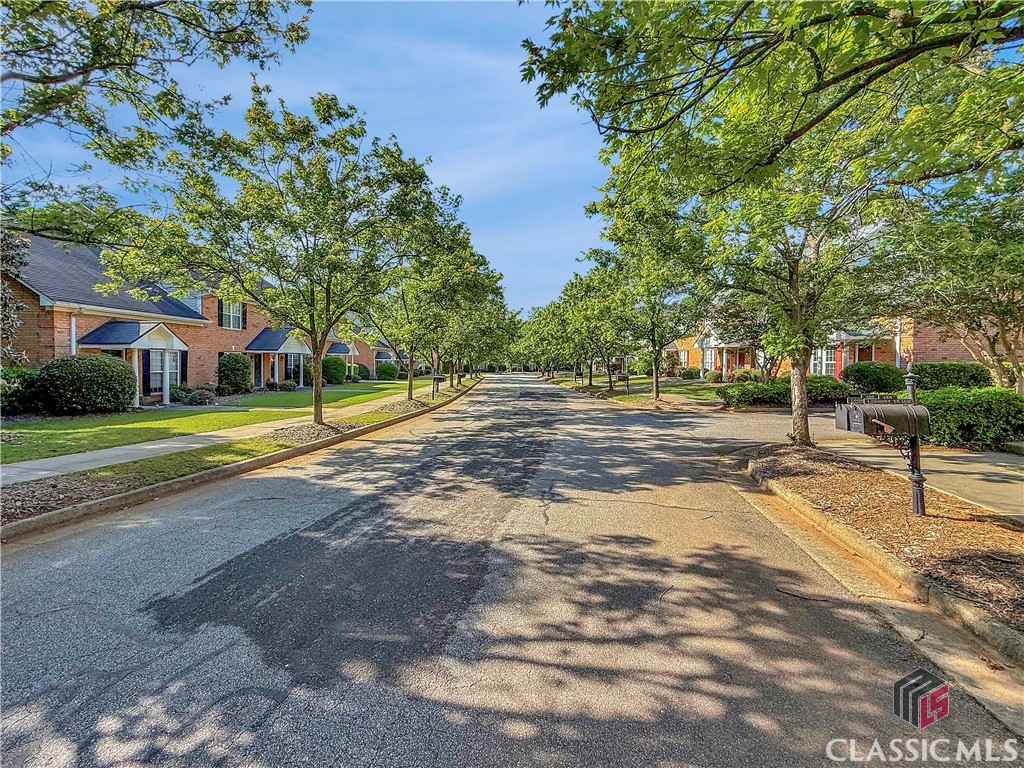 445 Logmont Trace, Unit 17 Athens, GA 30606 - Photo 25 of 28 Allen's Landing with trees and sidewalks on both sides of the street