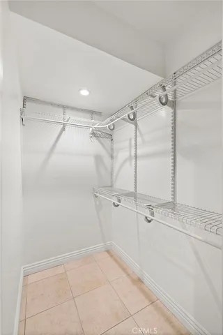 an empty room with fan and windows