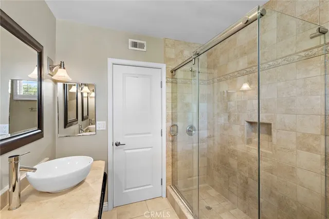 a bathroom with a granite countertop vanity mirror and a toilet