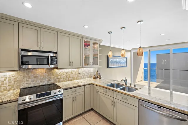 a kitchen with a sink and stainless steel appliances