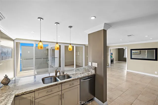 a kitchen with kitchen island a sink dining table and chairs