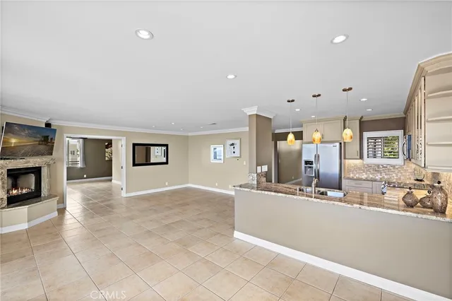 a large white kitchen with a sink and a stove top oven