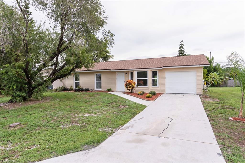 1770 52nd Terrace Southwest Naples, FL 34116 - Photo 1 of 23 a front view of house with a garden