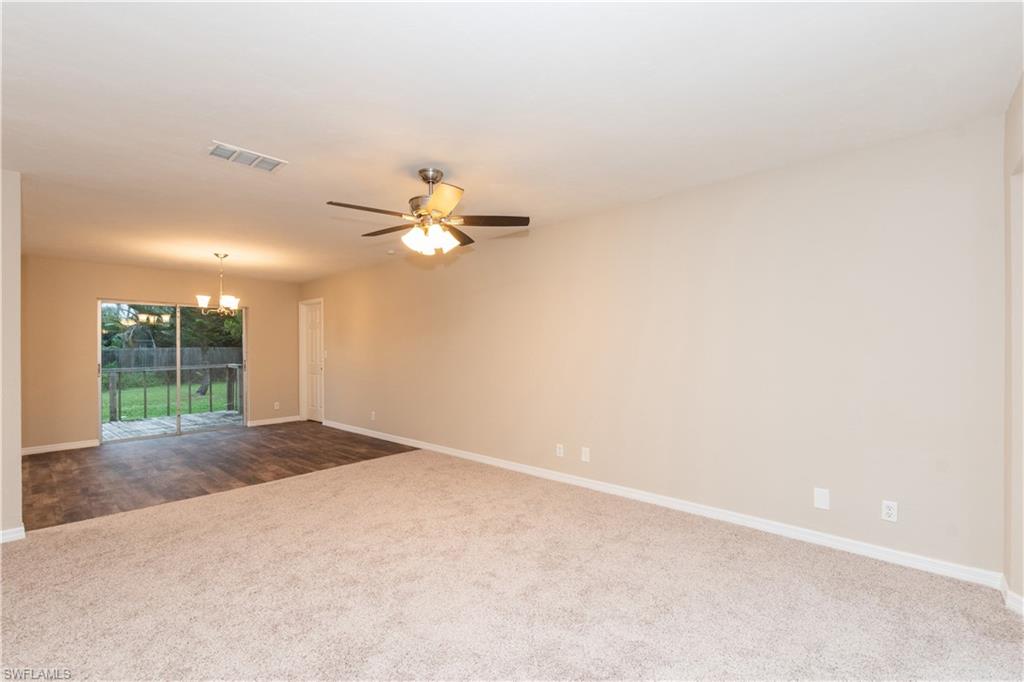 1770 52nd Terrace Southwest Naples, FL 34116 - Photo 12 of 23 an empty room with windows and chandelier fan