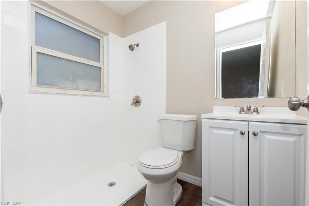 1770 52nd Terrace Southwest Naples, FL 34116 - Photo 20 of 23 a bathroom with a toilet a sink a mirror and vanity