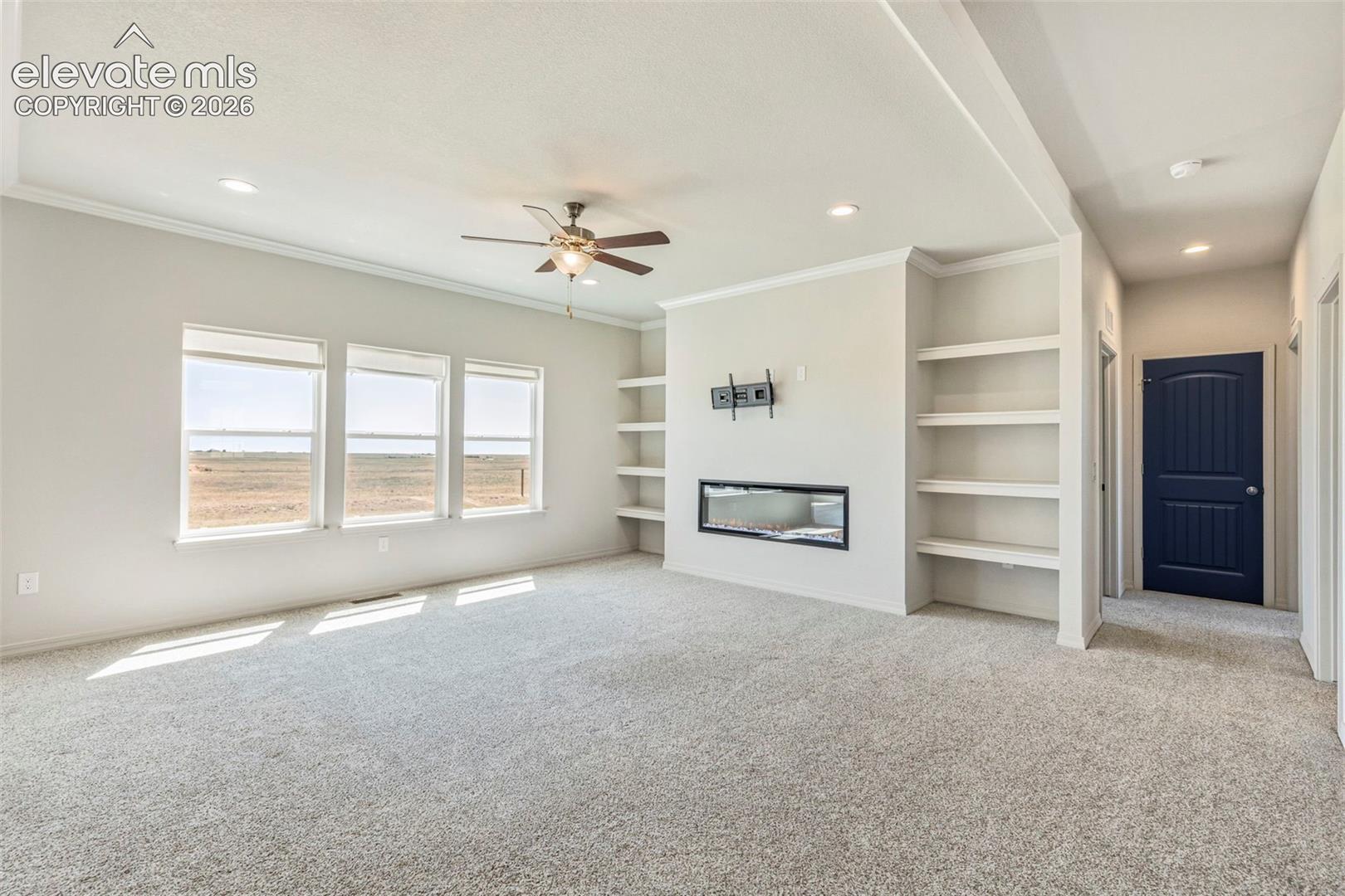 3955 North Yoder Road Yoder, CO 80864 - Photo 9 of 38 Spacious room featuring light-toned carpeting, multiple recessed lights, and a ceiling fan
