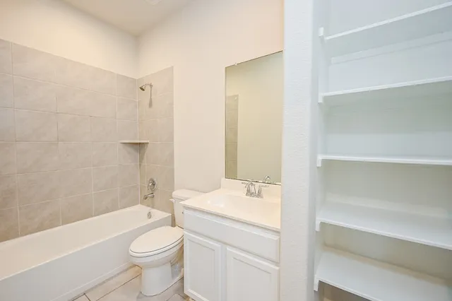 a bathroom with a toilet a sink and bathtub