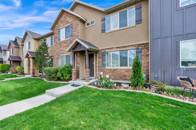 1179 West 100 South Springville, UT 84663 - Photo 2 of 32 Townhome exterior featuring a combination of stone veneer and stucco siding