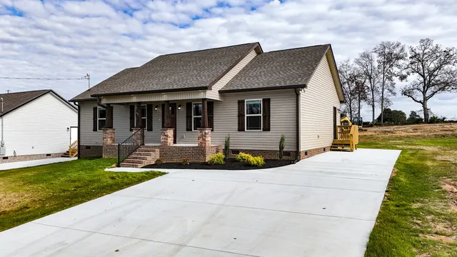 a front view of house with yard and green space