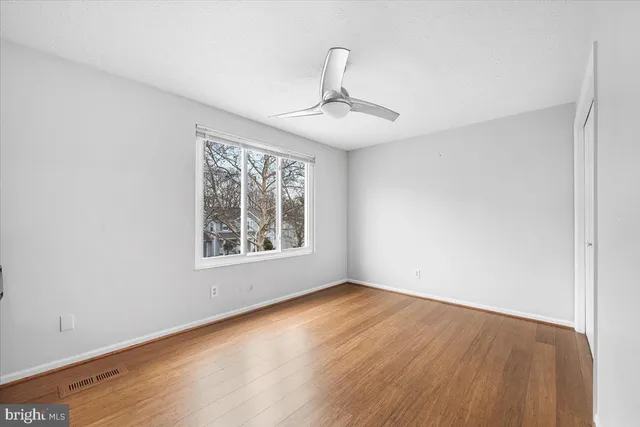 a view of kitchen cabinets with wooden floor