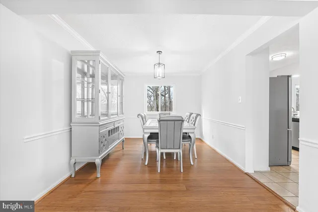 a view of kitchen with refrigerator and microwave