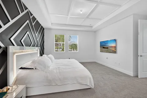 a bathroom with a granite countertop tub a sink and a large mirror
