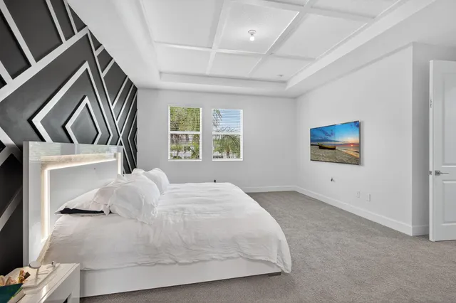 a bathroom with a granite countertop tub a sink and a large mirror