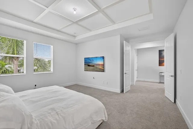 a spacious bathroom with a granite countertop sink a toilet mirror and bathtub