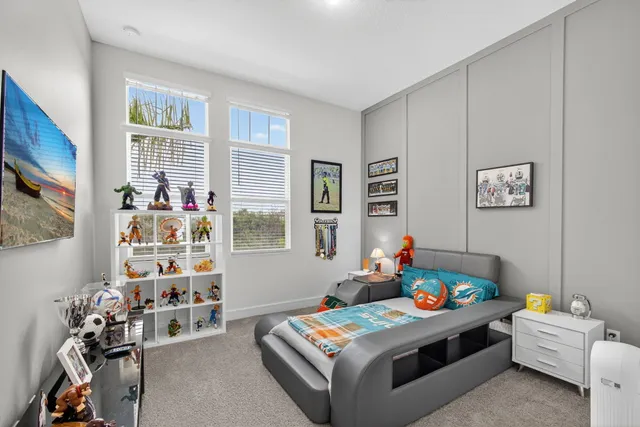 a bedroom with a bed and a book shelf