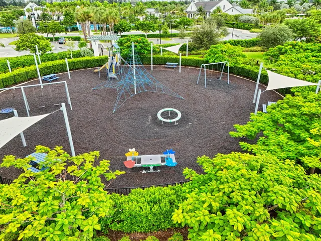 an aerial view of a house with a yard potted plants and large tree